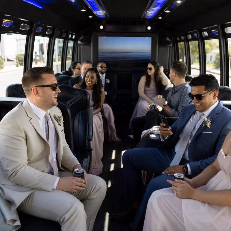 Wedding guests seated inside a Gilbert party bus