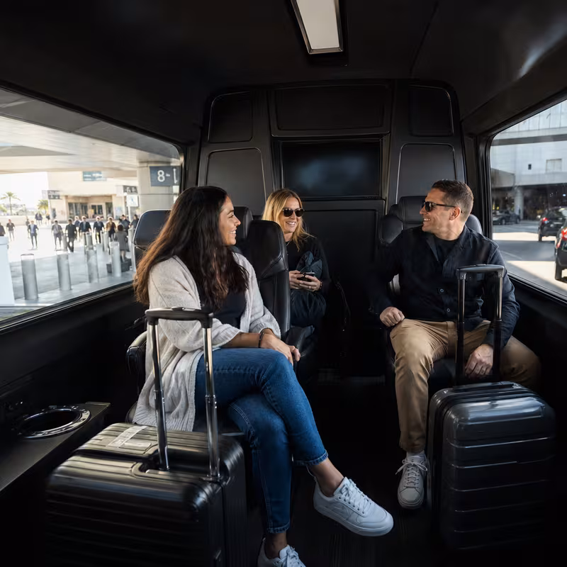 Passengers loading luggage while boarding an Gilbert group shuttle