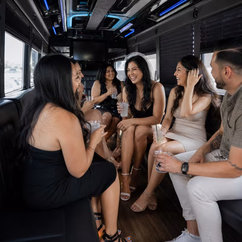 Party bus interior with wraparound leather seating and LED lighting in Gilbert