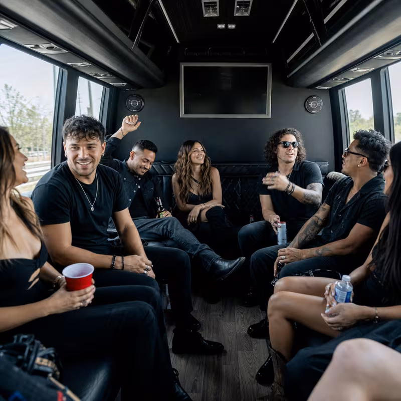 Group boarding a white charter bus for Concert Transportation transportation in Gilbert
