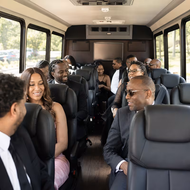 Group boarding a white charter bus for Private Event Transportation transportation in Gilbert