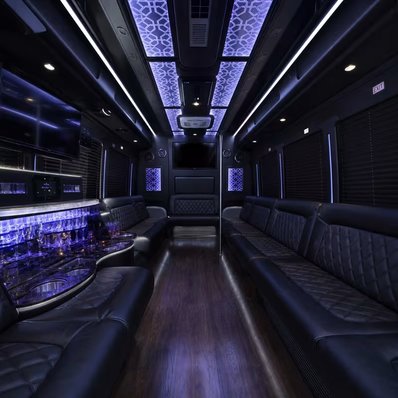 Party bus interior with wraparound leather seating and LED lighting in Gilbert