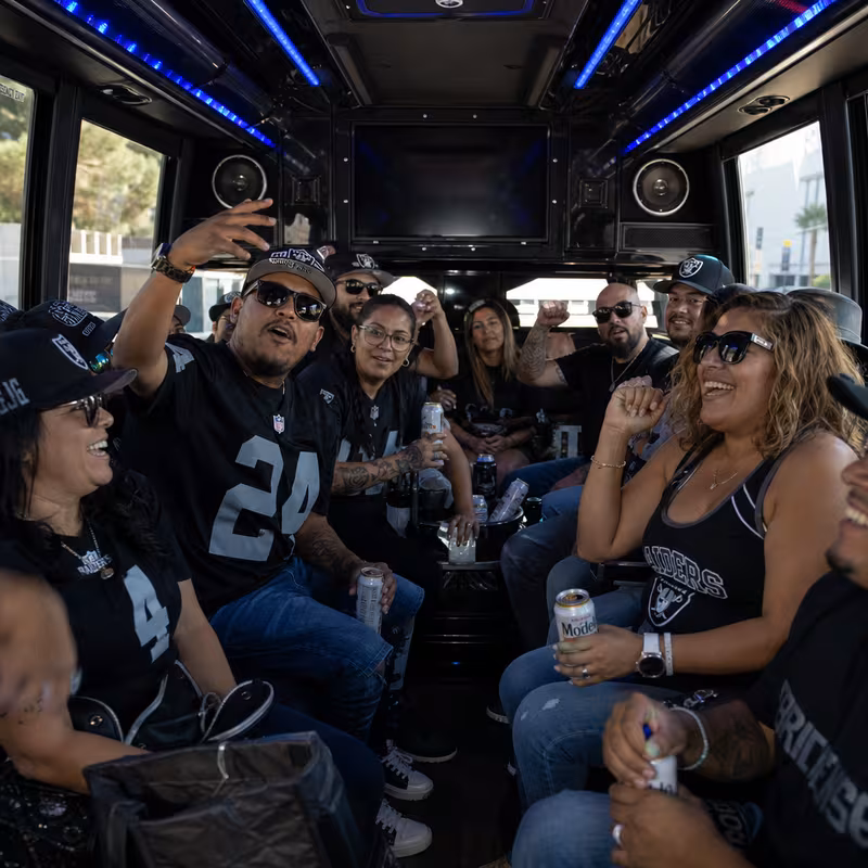 Group boarding a white charter bus for Sporting Event Transportation transportation in Gilbert