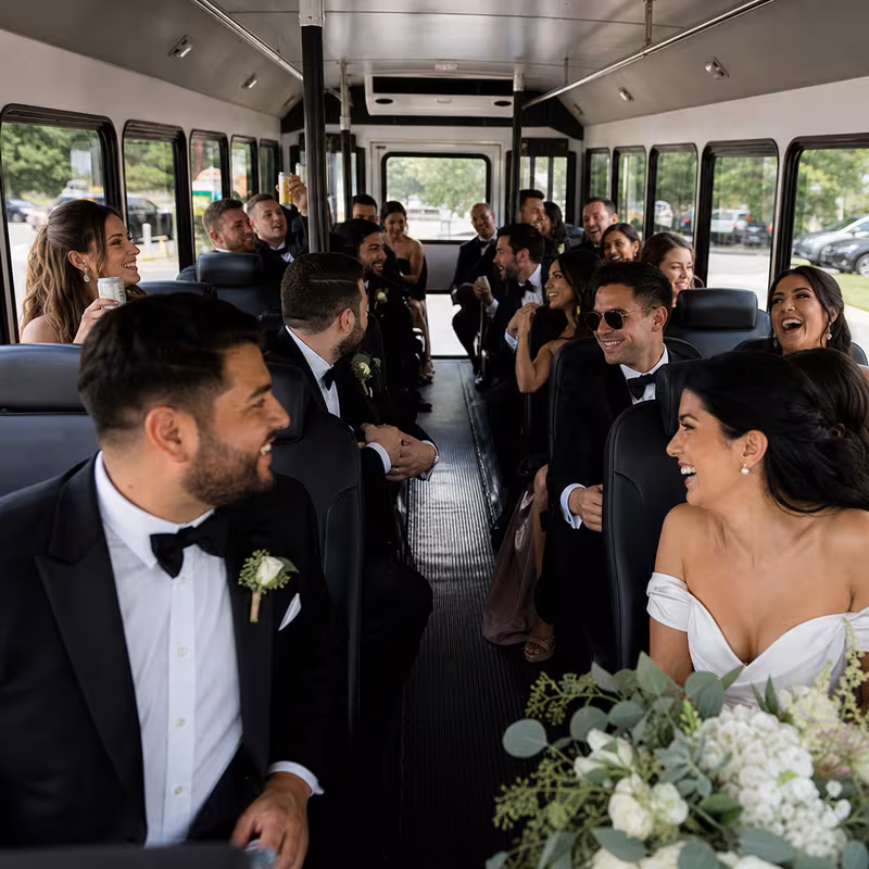 Group boarding a white charter bus for Wedding Transportation transportation in Gilbert