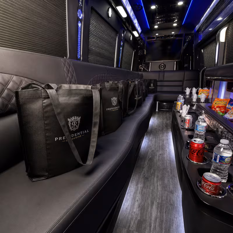 Party bus interior with wraparound leather seating and LED lighting in Gilbert